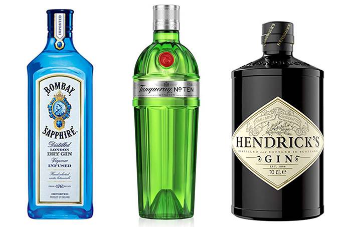 A imagem mostra 3 garrafas de gins diferentes alinhadas num fundo branco.